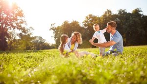 happy family sitting outside