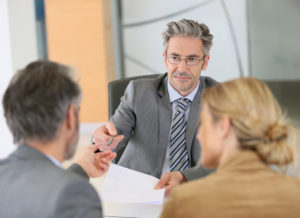 lawyer talking to husband and wife for their divorce
