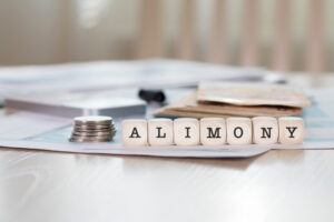 Word ALIMONY composed of wooden letters. Closeup