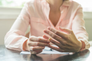 young woman pulling wedding ring