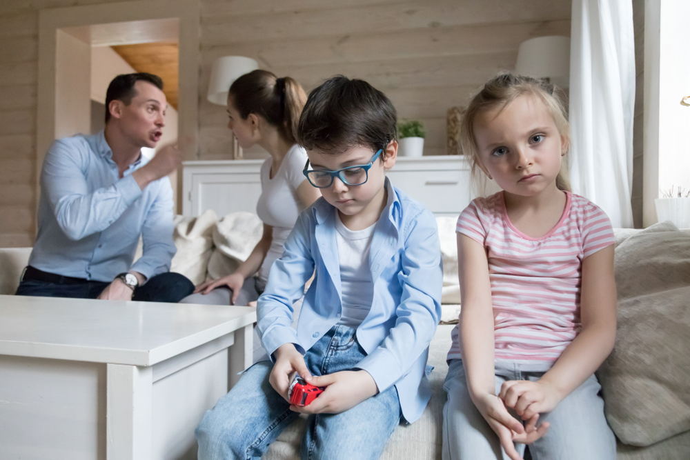 Sad children listen parents have angry fight at home