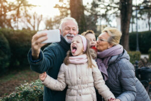 grandparents taking selfie photo with their grandchildren