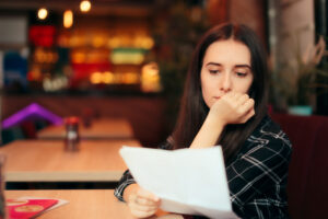 woman reading documents in a coffee shop