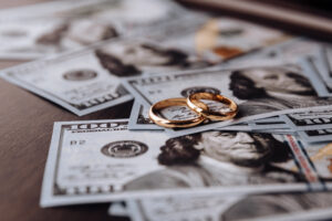 wedding rings on money background